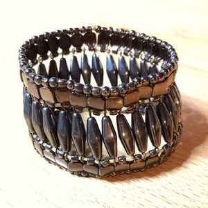 Metallic gold, bronze, dark brown wide stretchable bracelet.